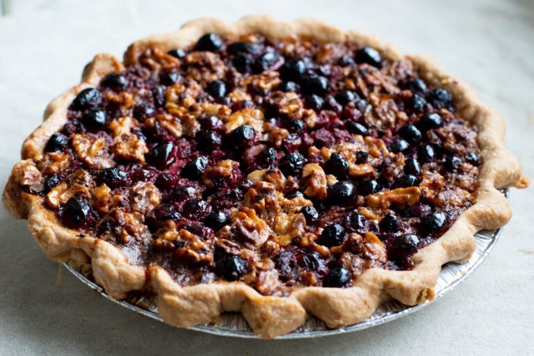 CRUST - Cranberry Walnut Pie - Our Cranberry Walnut Pie – Loads of tart cranberries and toasted walnuts are a brilliant, and beautiful, counterpoint to a brown sugar custard filling and flaky hand-crimped crust.